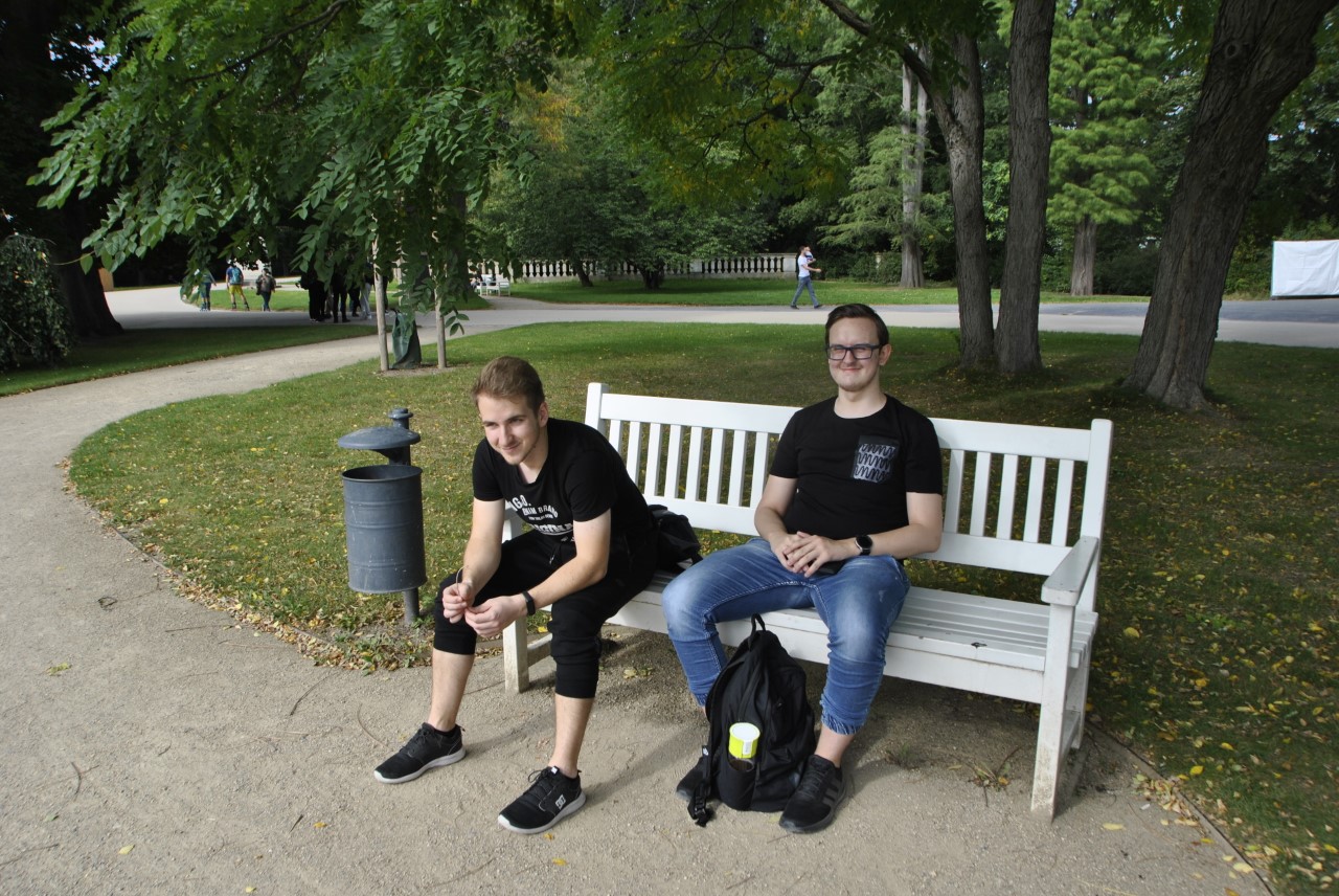 Dwóch uczniów na ławce w parku.